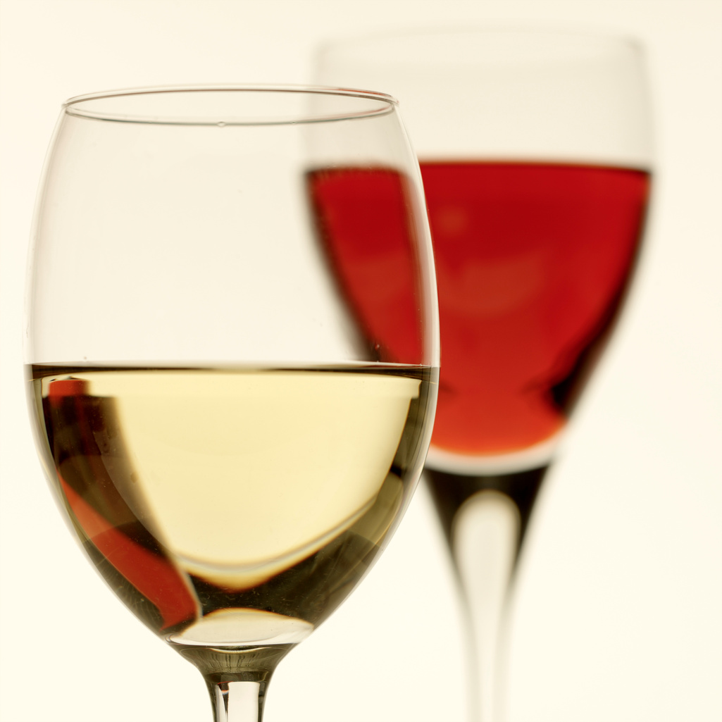 Close-up of glass of white wine with glass of red wine in the background